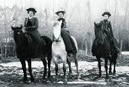 3 women sitting astride on horseback